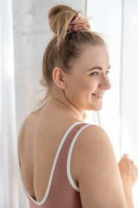 bodya różowa góra stroju kąpielowego na modelce – szerokie ramiączka, sportowy fason, z lamówką, widok z tyłu